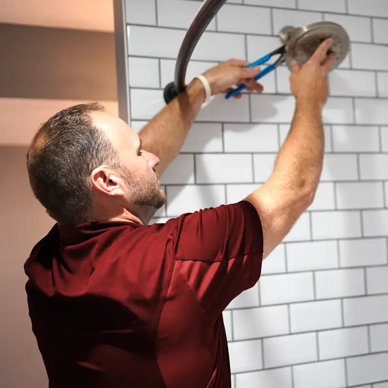 Plumber fixing a showerhead