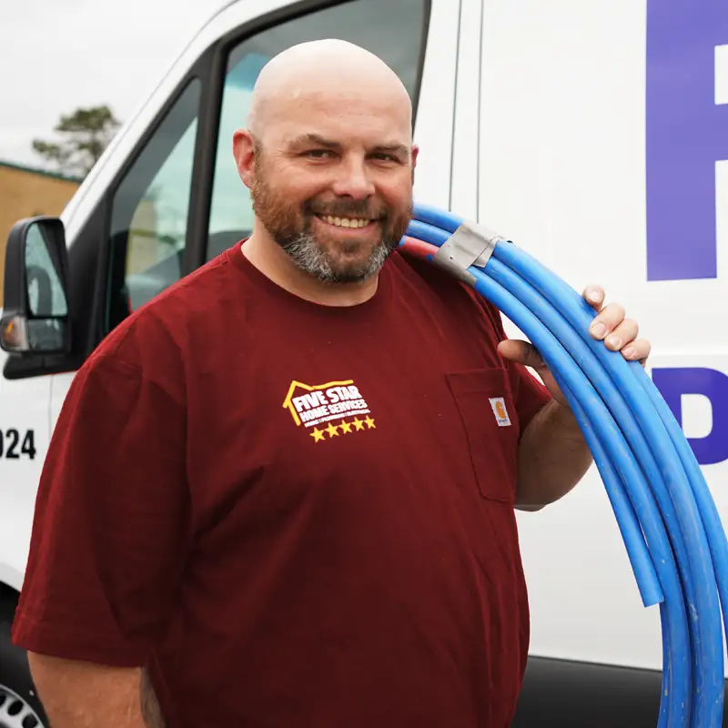 Plumber carrying a water line