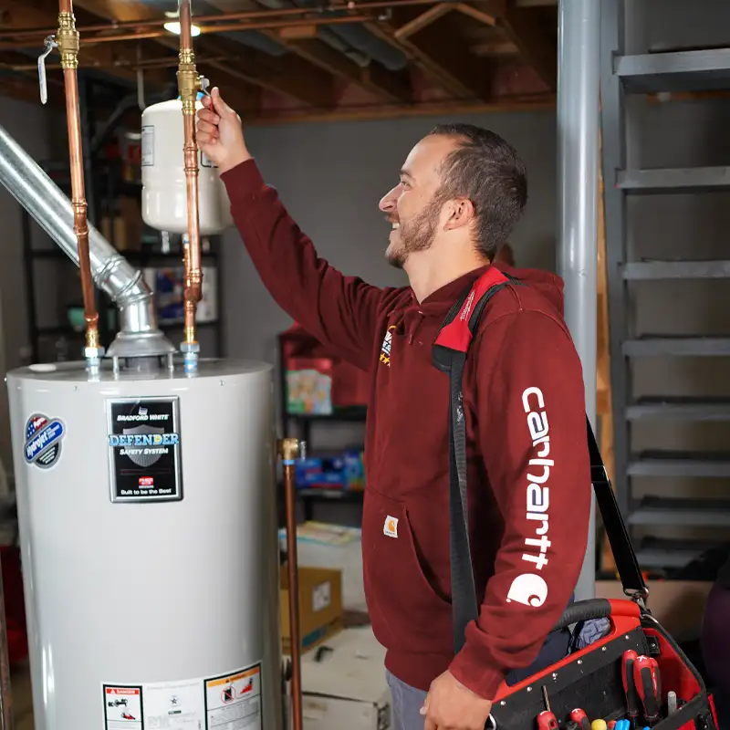 Plumber working on a water heater