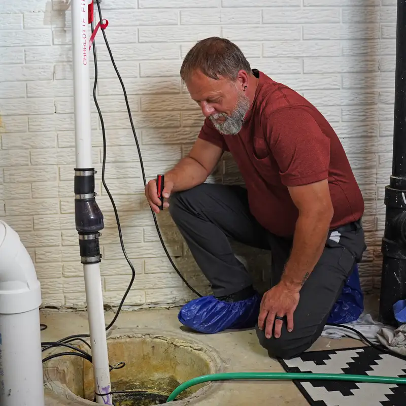 Plumber inspection a sump pump