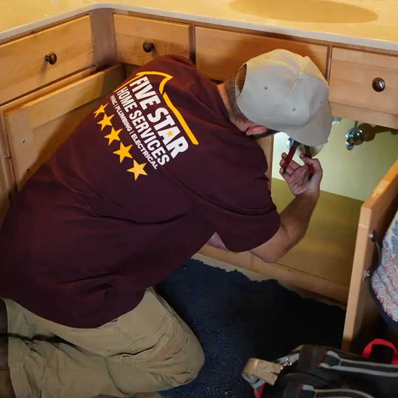 Plumber fixing a bathroom sink