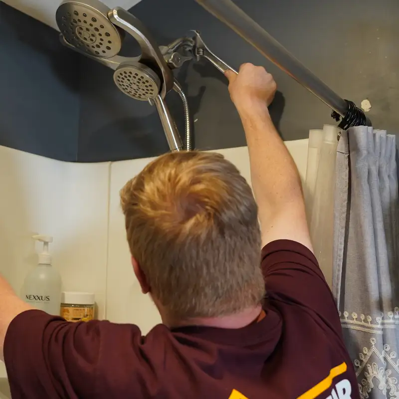 Plumber fixing a shower