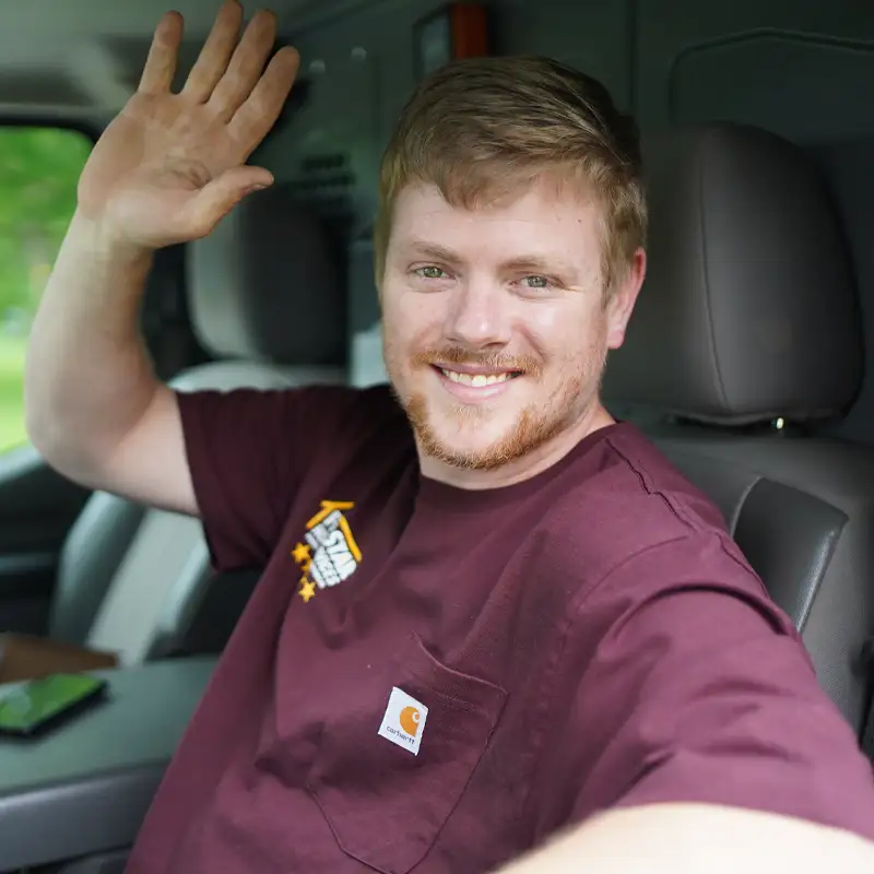 Plumber waving from a van