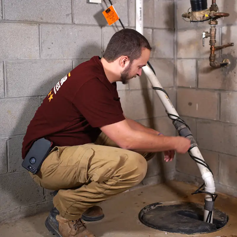 Plumber fixing a sump pump