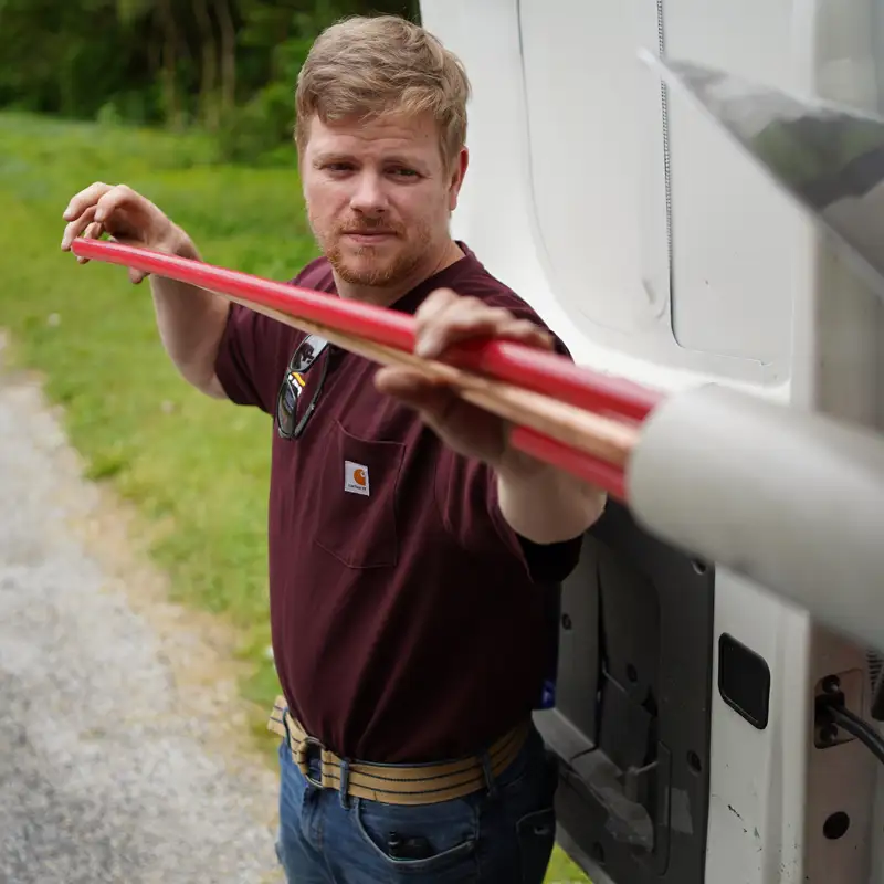 plumber holding piping