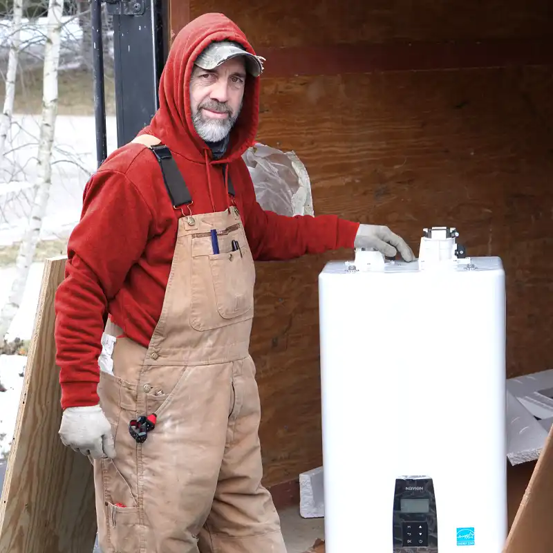 Plumber Standing Next to a Tankless Water Heater