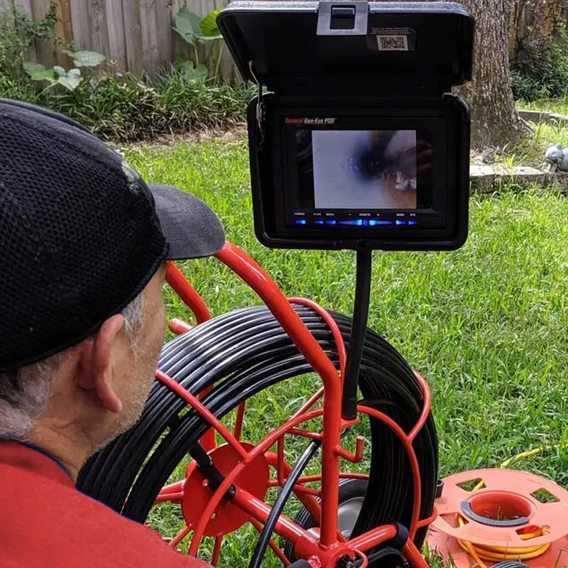 Plumber looking at a video camera inspection screen